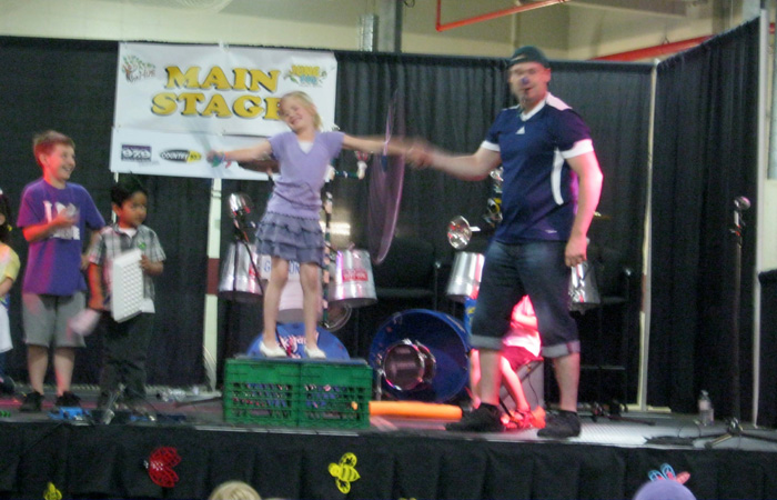 A girl learns to hoola-hoop.