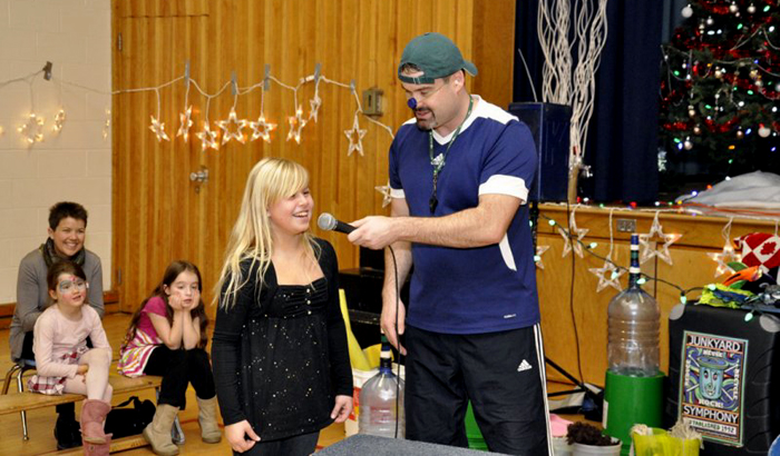 Jonny asks a volunteer her name.