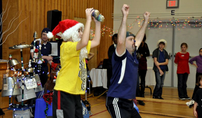 Jonny shows a volunteer how to move and shake like Santa.